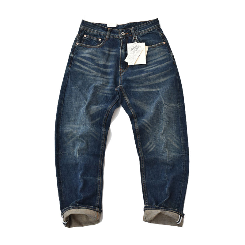 Straight denim pants with whiskered and distressed hem