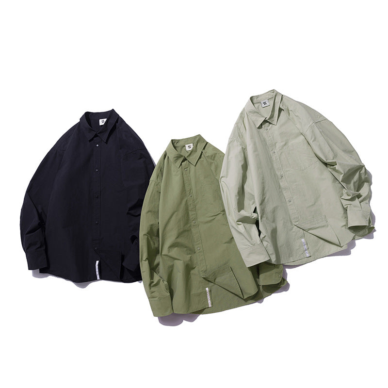 Choose from three colors of solid color irregular pocket long sleeve shirt