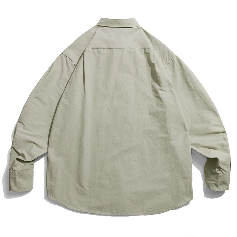 Choose from three colors of solid color irregular pocket long sleeve shirt