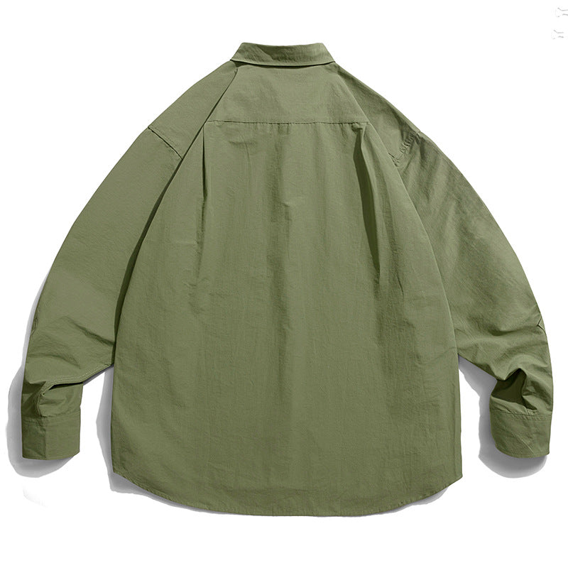 Choose from three colors of solid color irregular pocket long sleeve shirt