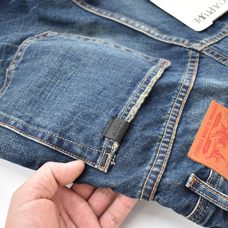 Straight denim pants with whiskered and distressed hem