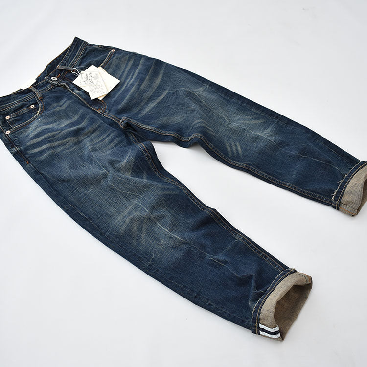 Straight denim pants with whiskered and distressed hem