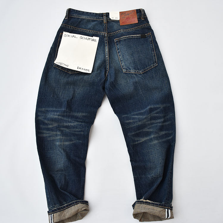 Straight denim pants with whiskered and distressed hem